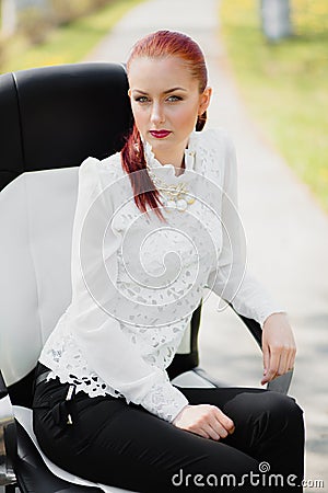 Beautiful girl sitting on the chair Stock Photo