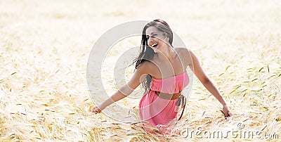 Beautiful girl smiling in a field of wheat Stock Photo