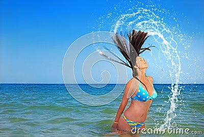 Beautiful girl splashing in the ocean Stock Photo