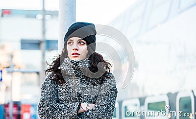 Beautiful girl standing near the railway station trying to hold back her tears - close up front view Stock Photo