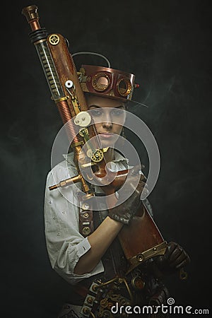 Beautiful girl steampunk in arms. Stock Photo