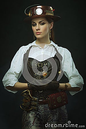 Beautiful girl steampunk. Posing with the clock Stock Photo