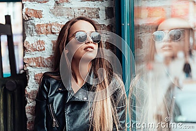 Beautiful girl in sunglasses posing on camera Stock Photo