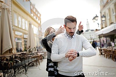 Beautiful girl surprises boyfriend waiting for her Stock Photo