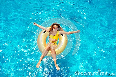Beautiful girl swim in pool on inflatable doughnut Stock Photo