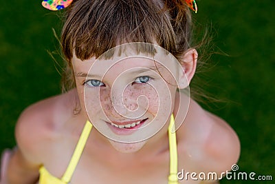 Young girl in a swimsuit on a shelf by the pool Stock Photo