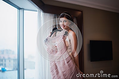 Beautiful girl tries on a pink wedding dress Stock Photo