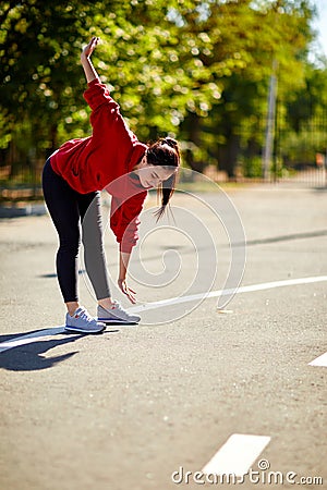 The girl bends, stretches, stretches to her toes Stock Photo