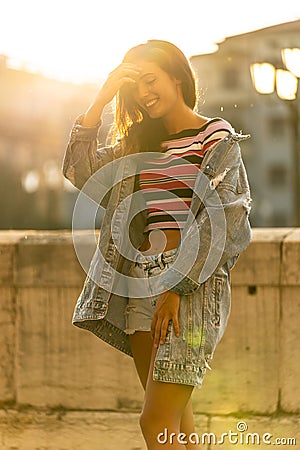 Caucasian beautiful women smiling in city in the sunset Stock Photo