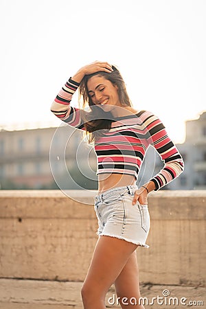 Caucasian beautiful women smiling in city in the sunset Stock Photo