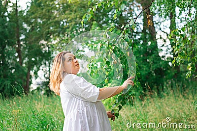 Beautiful girl walks in the park in summer Stock Photo