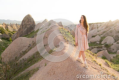 a beautiful girl walks on the top of the mountain enjoying the view Stock Photo