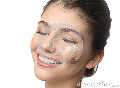 Beautiful girl on white, closeup. Using concealer and foundation for face contouring Stock Photo