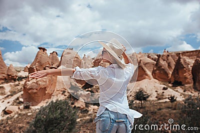 a beautiful girl in a white shirt and hat catches a ride to hitchhike Stock Photo