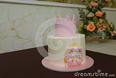 Beautiful girlish birthday cake with pink mastic crown, roses, bow, inscription name Maria. One year old or five years old Stock Photo