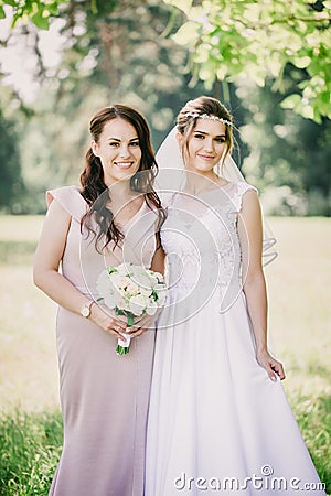 Beautiful girls Bride and bridesmaid with a bouquet, close-up Stock Photo