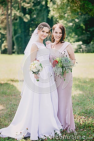 Beautiful girls Bride and bridesmaid with bouquets Stock Photo