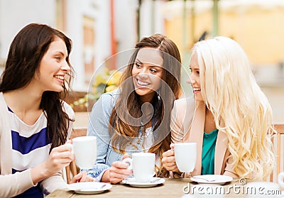 Beautiful girls drinking coffee in cafe Stock Photo