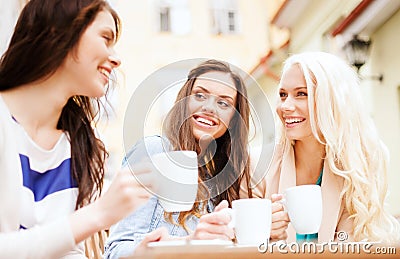 Beautiful girls drinking coffee in cafe Stock Photo