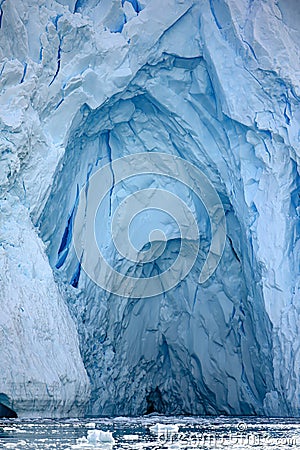 Glacier wall in Antarctica, Majestic blue ice wall with shape of arch. Stock Photo