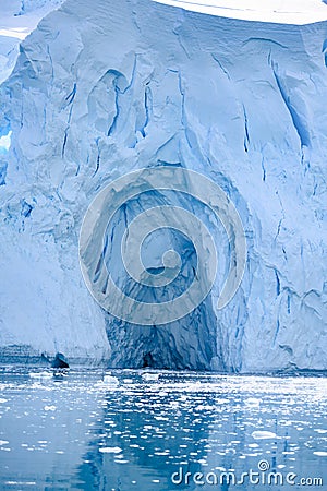 Glacier wall in Antarctica, majestic blue and white ice wall with shape of arch. Stock Photo