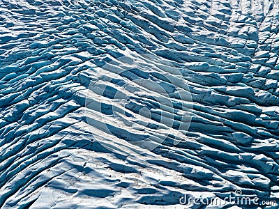 Beautiful glaciers flow through the mountains in Iceland. Aerial view and top view. Flowing Glacier in Greenland. Stock Photo