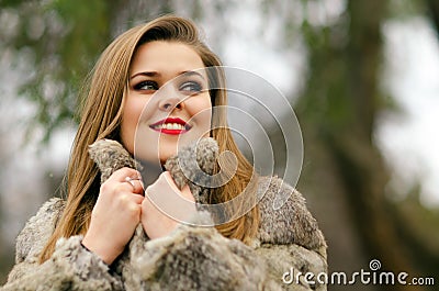 Beautiful glamorous lady having fun outdoor on gloomy winter day Stock Photo