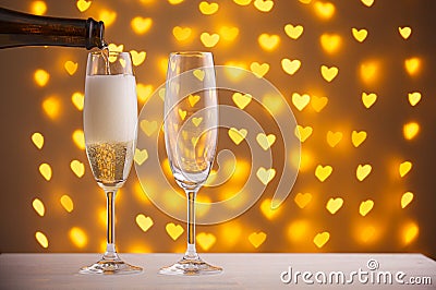 Beautiful glasses of champagne on a blurred background of hearts Stock Photo