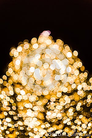 Beautiful gold-colored bokeh lights in the dark - perfect for a lit background Stock Photo