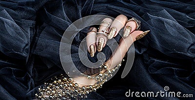 Beautiful gold manicure nails . Manicure and nails concept. Trendy nails Stock Photo