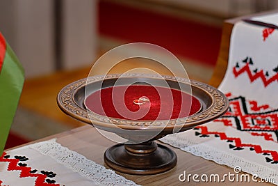 Beautiful gold rings in a wooden bowl with red velvet Stock Photo