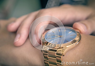 Beautiful golden fashion watch on a girl hand Stock Photo