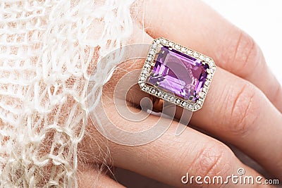 Beautiful golden ring with a large amethyst on a female hand Stock Photo