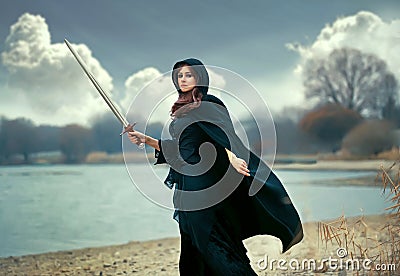The beautiful gothic girl with sword Stock Photo