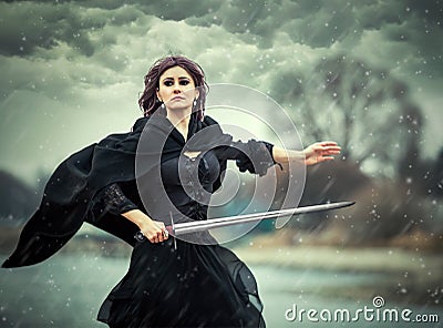 The beautiful gothic girl with sword Stock Photo