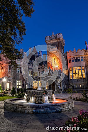 Beautiful Gothic Revival style mansion and fountain at dusk. Toronto Editorial Stock Photo