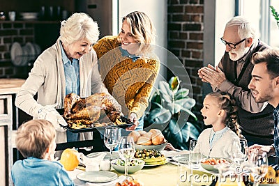 beautiful grandmother carrying turkey for family Stock Photo