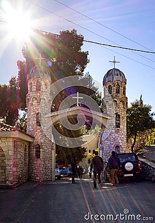 Beautiful Greek church of yellow color on a sunny day in the mountains on an island Evia in Greece Editorial Stock Photo