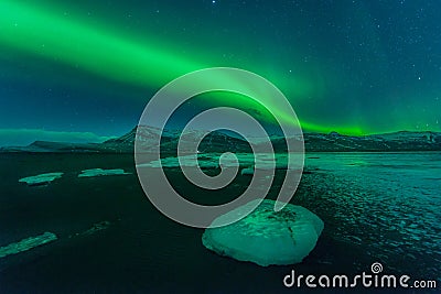 A beautiful green and red aurora over the Jokulsarlon lagoon, Iceland Stock Photo