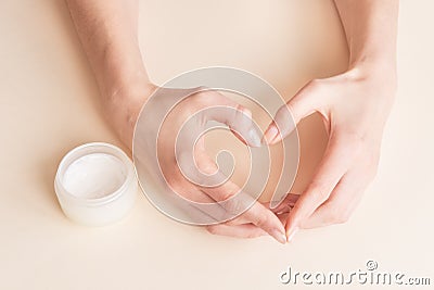 Beautiful groomed woman`s hands with body and skin cream on a light background Stock Photo