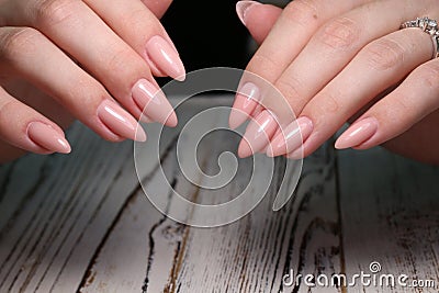 Beautiful groomed woman& x27;s hands, nails on the light gray background Stock Photo