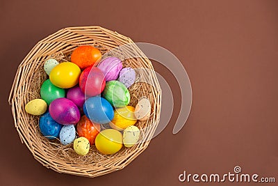 Beautiful group Easter eggs in the spring of easter day, red eggs, blue, purple and yellow in Wooden basket on the brown Stock Photo