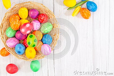 Beautiful group Easter eggs in the spring of easter day, red eggs, blue, purple and yellow in Wooden basket with tulips on the Stock Photo