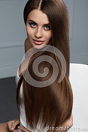 Beautiful Hair Color. Woman With Glossy Straight Brown Long Hair Stock Photo