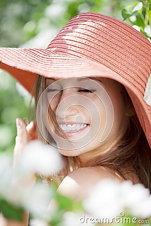 Beautiful half-naked woman among flowering gardens Stock Photo