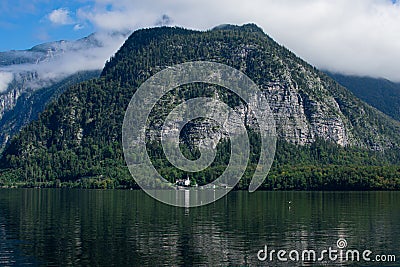 The beautiful HallstÃ¤tter See on a sunny autumn day with blue sky and clouds Stock Photo