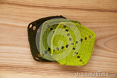 A beautiful hand crocheted pattern pieces of vibrant color gradient in green tones Stock Photo