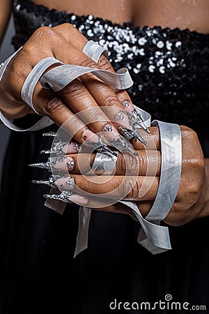 Beautiful hand of the girl with dark skin graft of acrylic nails with nail unusual fotmoy Stock Photo