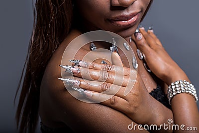Beautiful hand of the girl with dark skin graft of acrylic nails with nail unusual fotmoy Stock Photo