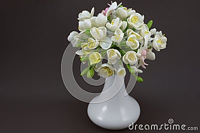 Hand made polymer clay bouquet in a white vase on a dark background Stock Photo
